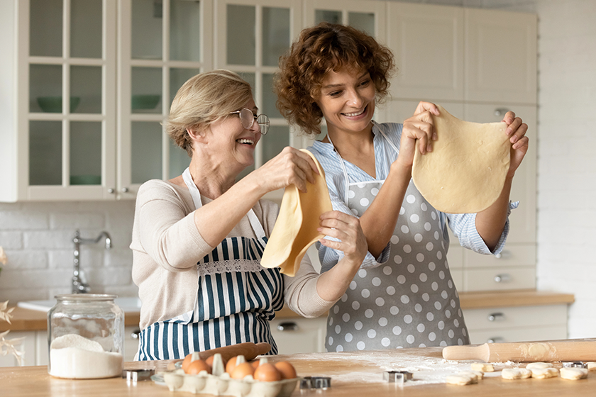 happy-young-woman-with-mature-mother-cooking